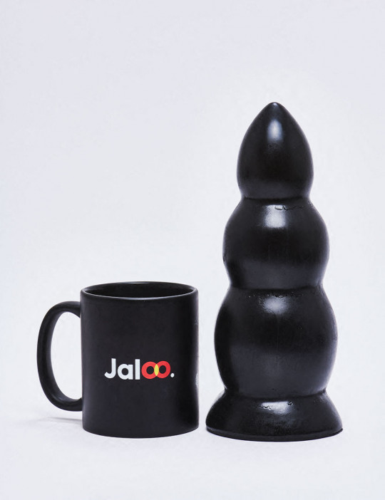XL Dildo from All Black in 23cm compared to a mug