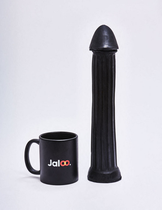 XL Dildo from All Black in 31cm compared to a mug