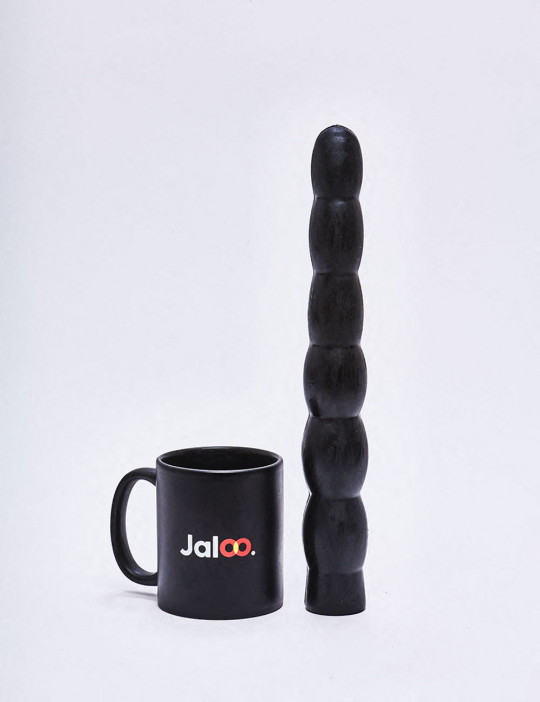 XL Dildo from All Black in 32cm compared to a mug